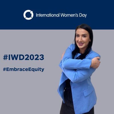 Claire embrassing herself on #IWD2023 background