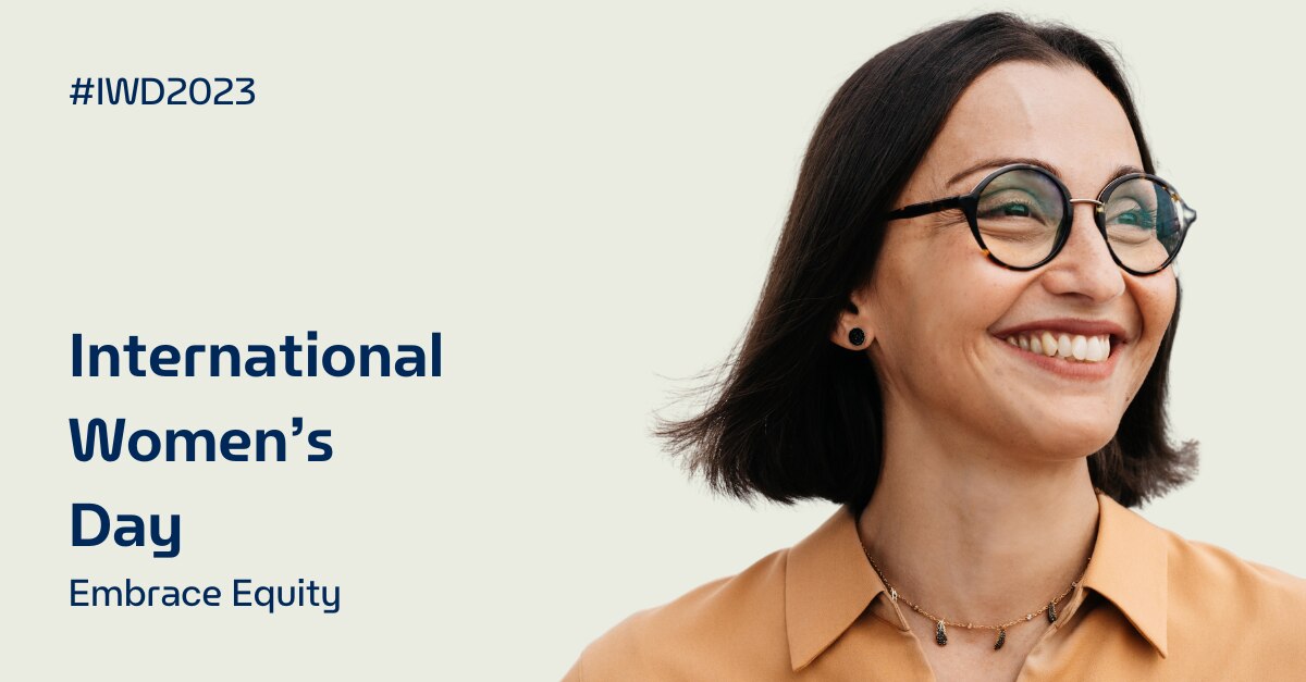 Woman smiling with "International Women's Day Embrace Equity" written on the background