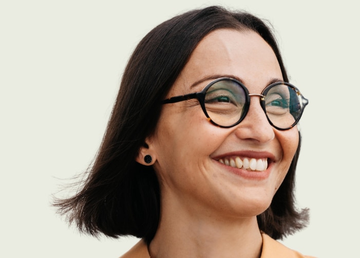 Woman smiling with "International Women's Day Embrace Equity" written on the background