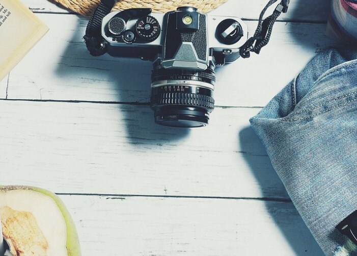 Camera, coconut, book, glasses, sunglasses, and jeans