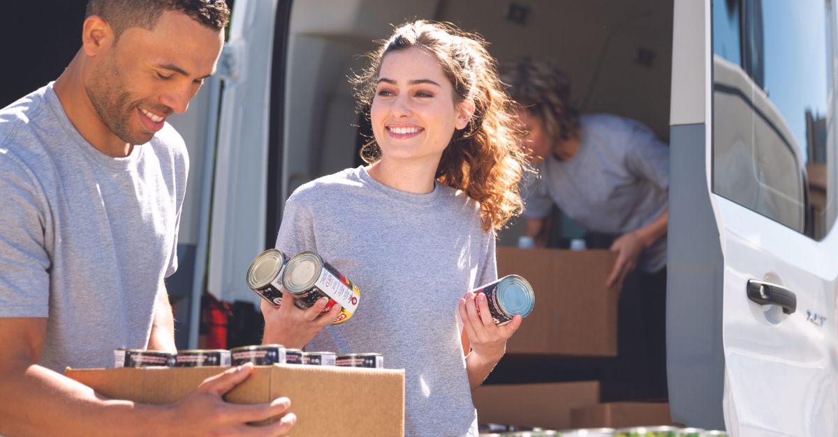 two university students packing tins of food ready to start university