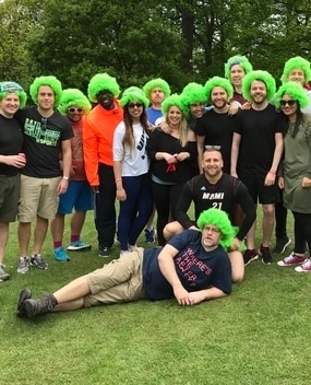 Employees in fluffy green hats