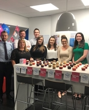 Group of employees with cupcakes