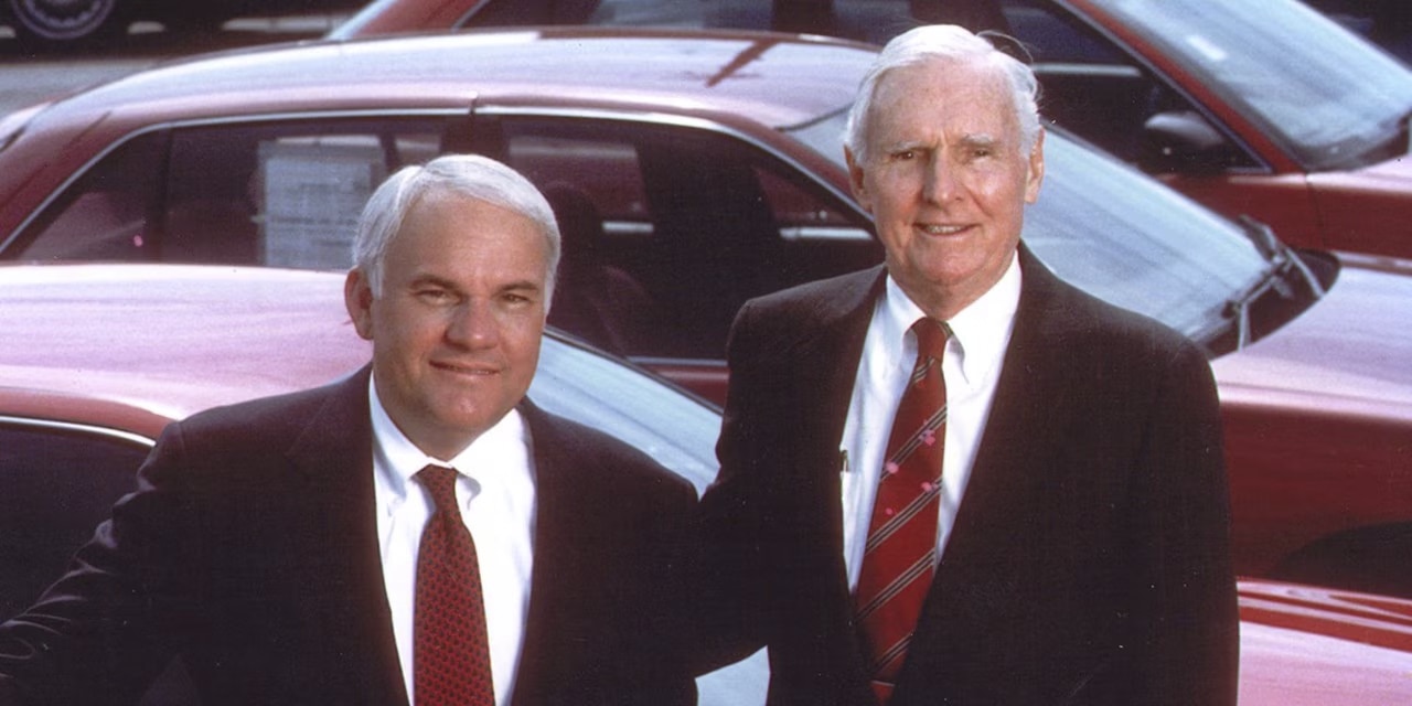 Jack and Andy Taylor stand for a picture in red ties and black suits