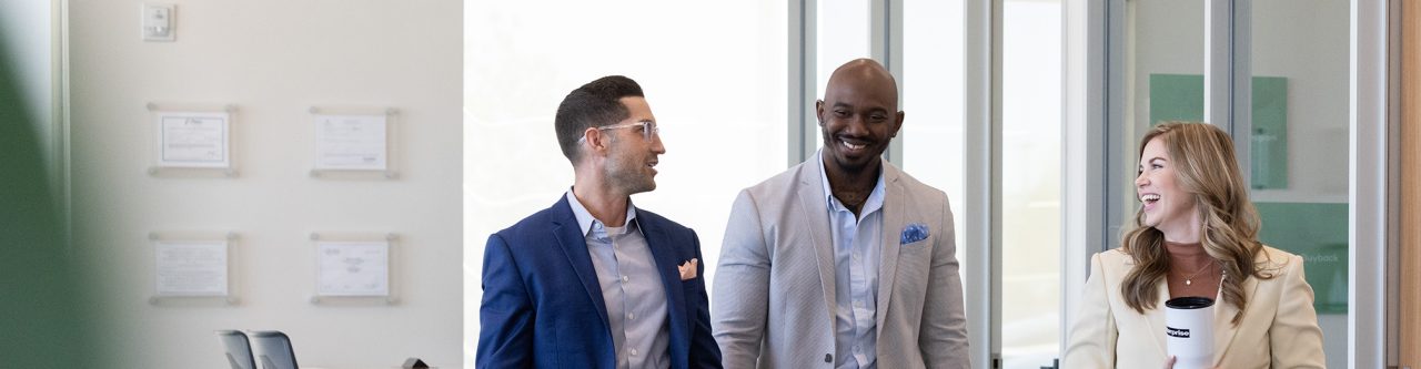 Three Enterprise Mobility employees walk and talk at work